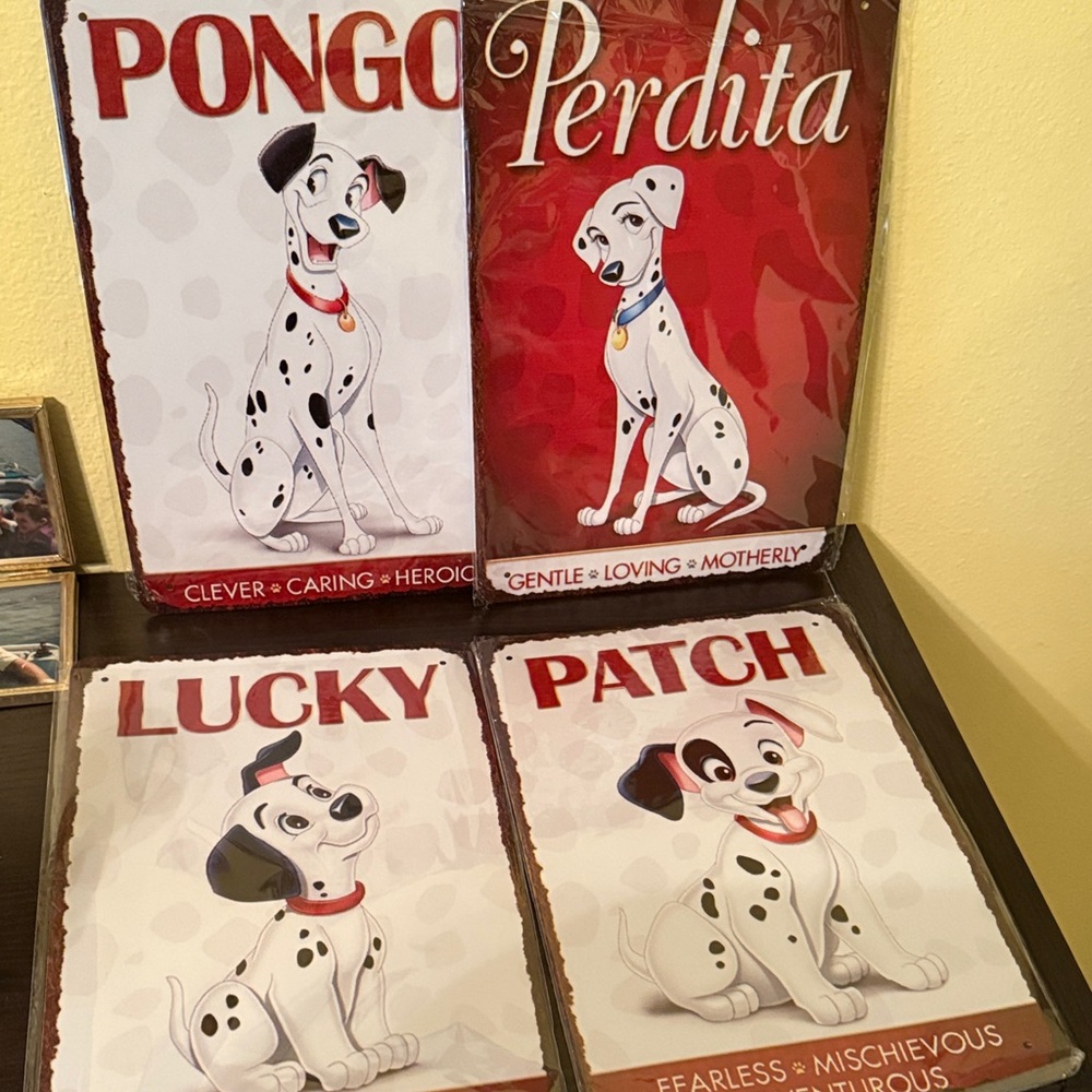 Four metal 101 Dalmatian signs